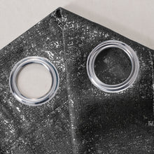 Load image into Gallery viewer, Close-up of a black curtain with two circular metal grommets.