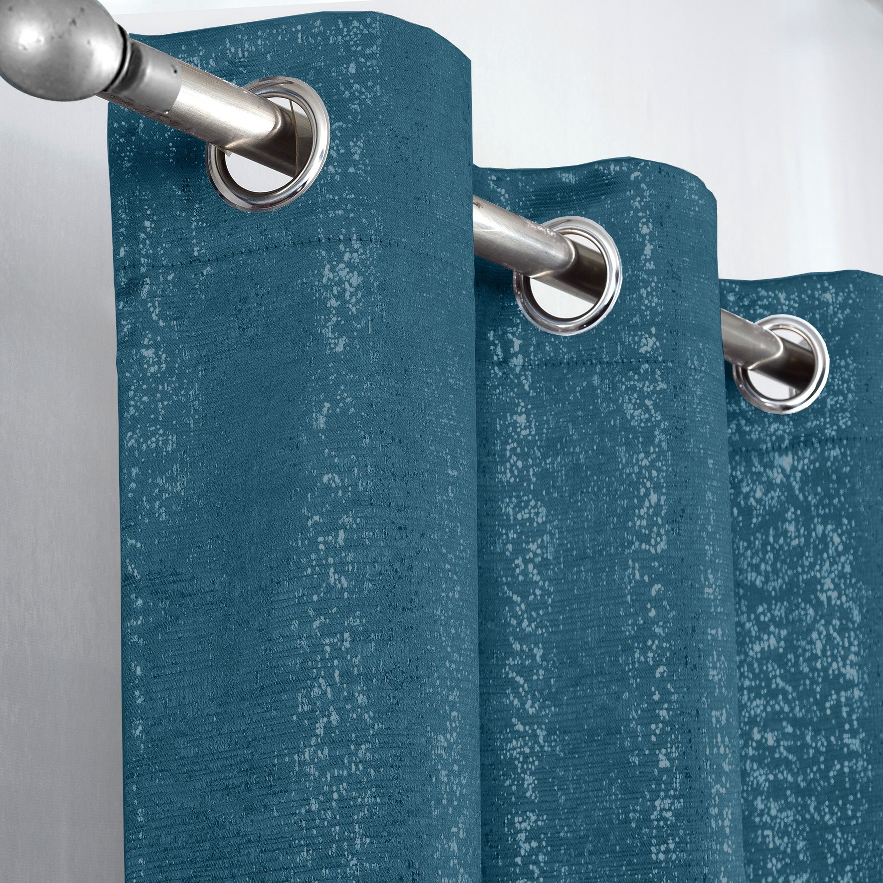 Teal Glittery curtain with silver grommets on a gray background